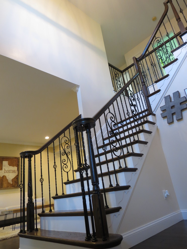 Staircase - large transitional galley dark wood floor and brown floor staircase idea with a double-bowl sink, raised-panel cabinets, white cabinets, granite countertops, white backsplash, porcelain backsplash, stainless steel appliances and an island