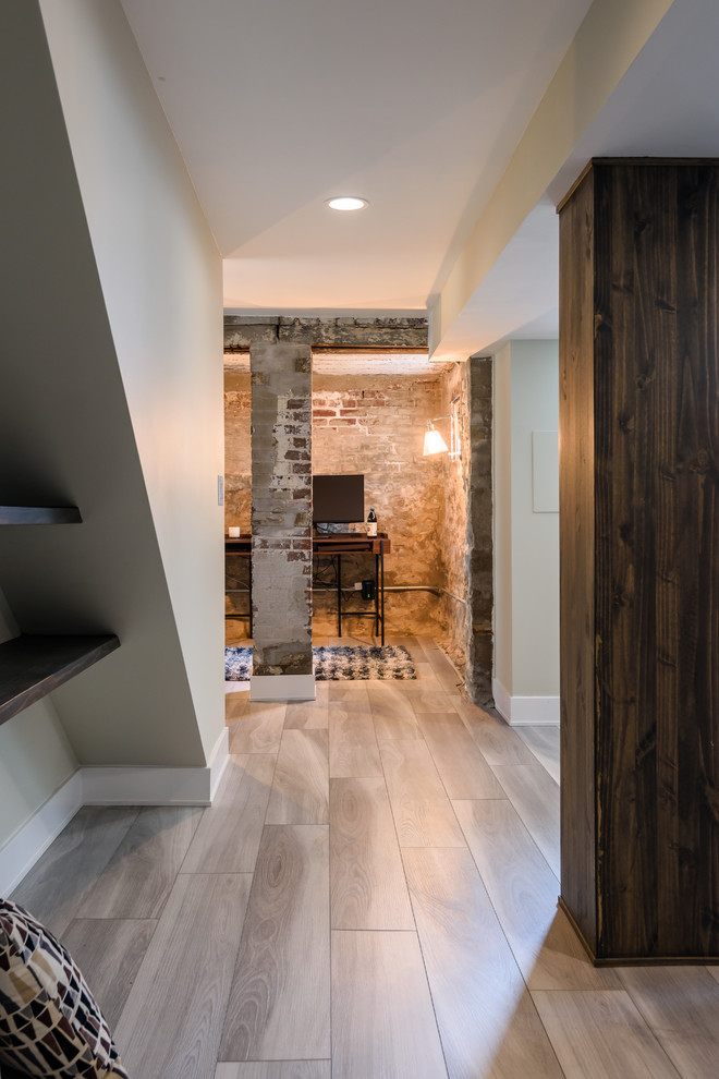 Inspiration for a mid-sized modern walk-out vinyl floor and gray floor basement remodel in St Louis with green walls