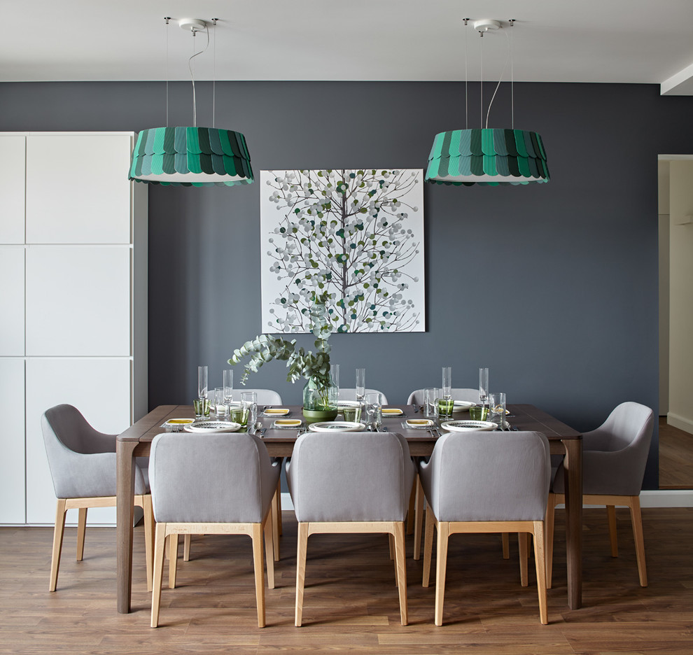 This is an example of a mid-sized scandinavian separate dining room in Moscow with grey walls and medium hardwood floors.