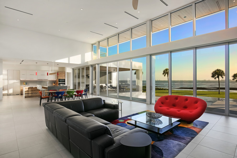 Inspiration for a large modern open concept living room in Tampa with white walls, porcelain floors, a ribbon fireplace, a stone fireplace surround, a wall-mounted tv and grey floor.
