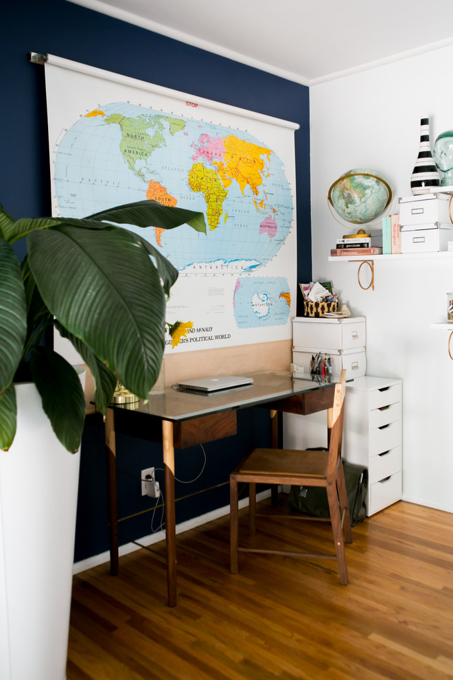 Study room - mid-sized eclectic freestanding desk medium tone wood floor study room idea in Los Angeles with blue walls
