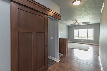 Inspiration for a mid-sized transitional medium tone wood floor foyer remodel with gray walls and a white front door