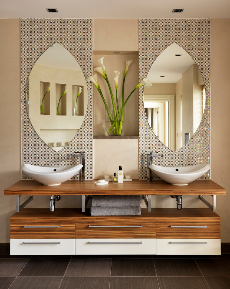 Photo of a large contemporary master bathroom in London with multi-coloured tile, mosaic tile, a vessel sink and beige walls.