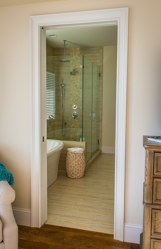 This is an example of a small transitional 3/4 bathroom in Charleston with beige cabinets, a freestanding tub, a corner shower, a one-piece toilet, beige walls, porcelain floors, engineered quartz benchtops, louvered cabinets, beige tile and a vessel sink.