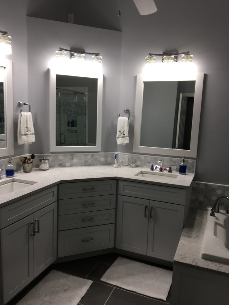 Large transitional master gray tile, white tile and porcelain tile porcelain tile and gray floor drop-in bathtub photo in Baltimore with shaker cabinets, white cabinets, purple walls, an undermount sink, quartz countertops, a hinged shower door and white countertops