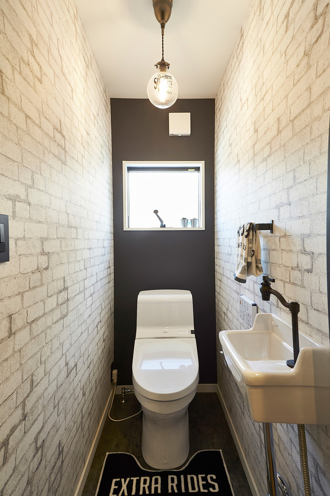 Inspiration for an industrial powder room in Fukuoka with grey walls, a console sink and grey floor.