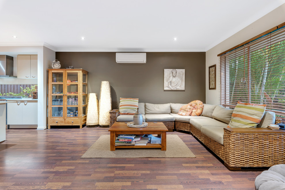 Eclectic formal open concept living room in Brisbane with beige walls, dark hardwood floors and brown floor.