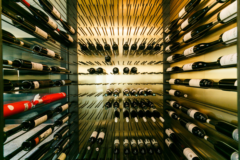 Photo of a mid-sized modern wine cellar in New York with slate floors and display racks.