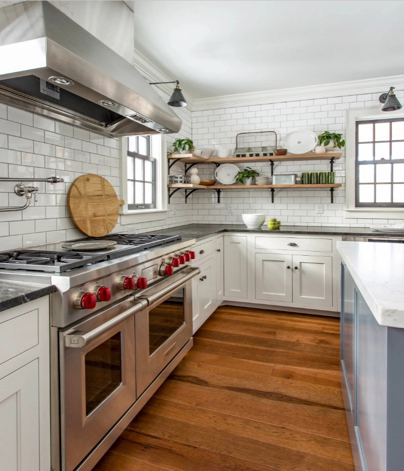 Design ideas for a country kitchen in Boston with stainless steel appliances, medium hardwood floors and with island.