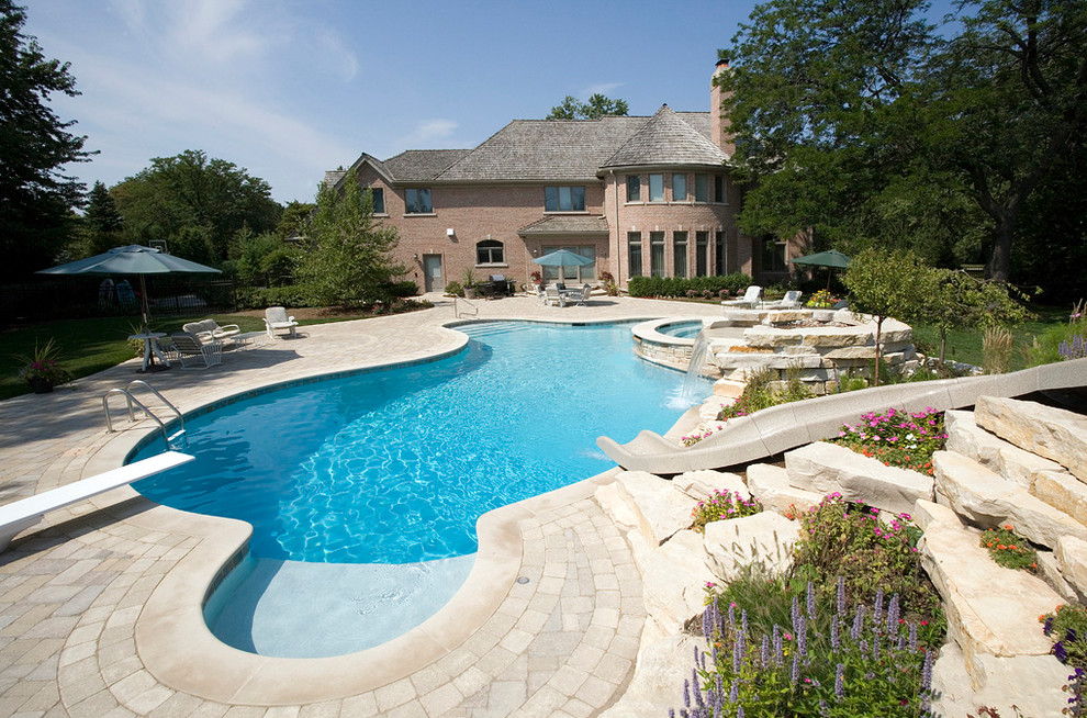 Inspiration for a large transitional backyard stone and custom-shaped lap hot tub remodel for summer in Chicago