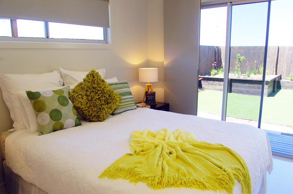 Photo of a small contemporary guest bedroom in Other with white walls, ceramic floors, no fireplace and white floor.