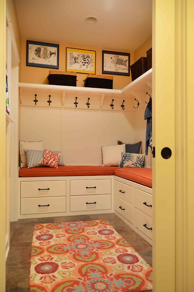 Inspiration for a mid-sized traditional mudroom in New York with beige walls, ceramic floors and brown floor.