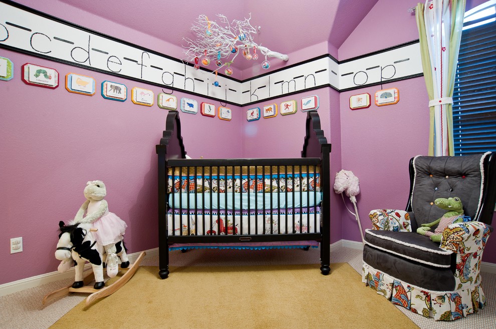 This is an example of an eclectic nursery for girls in Austin with purple walls and carpet.