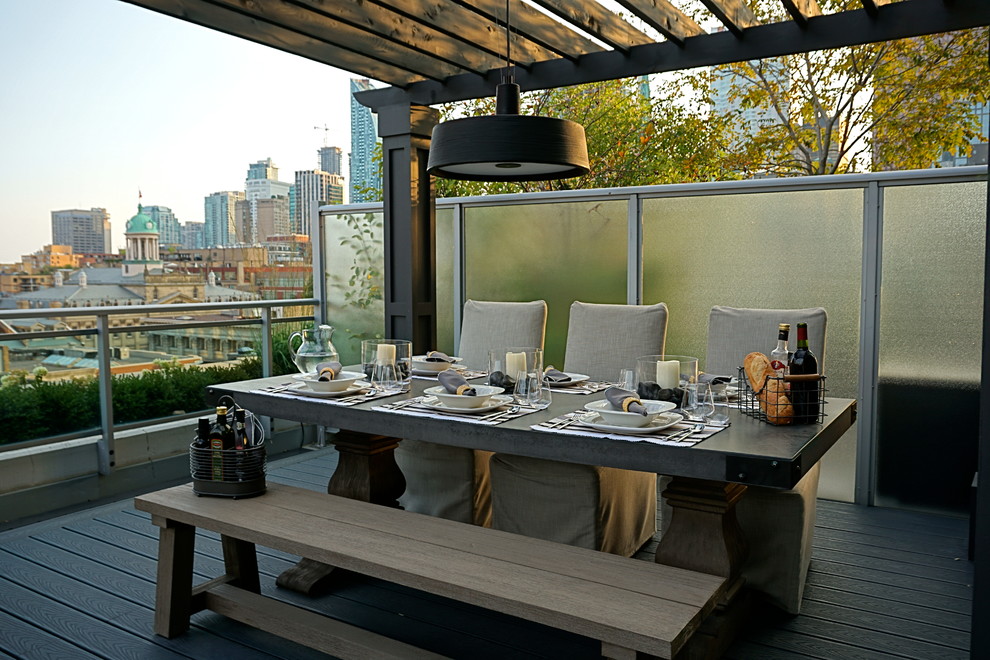 Photo of a transitional rooftop and rooftop deck in Toronto with a pergola.