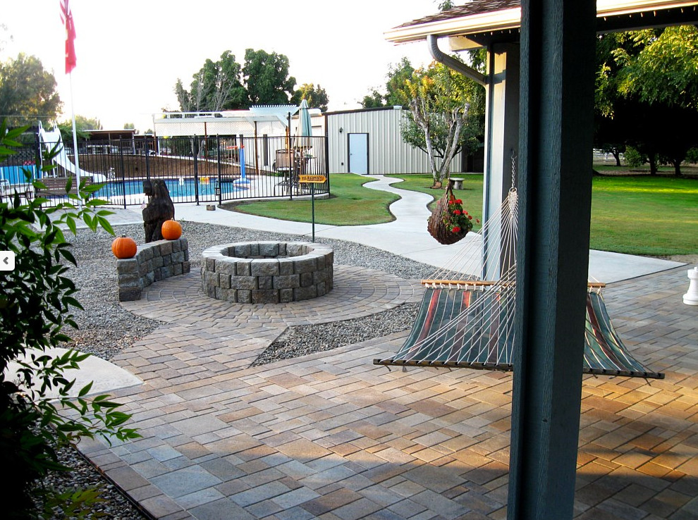 Inspiration for a large transitional backyard stone patio remodel in Phoenix with no cover