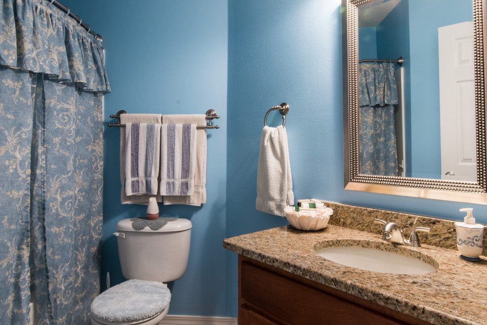 Bathroom - mid-sized single-sink bathroom idea with raised-panel cabinets and a built-in vanity