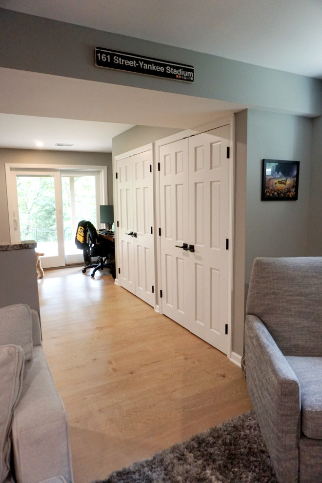 Example of a transitional vinyl floor basement design