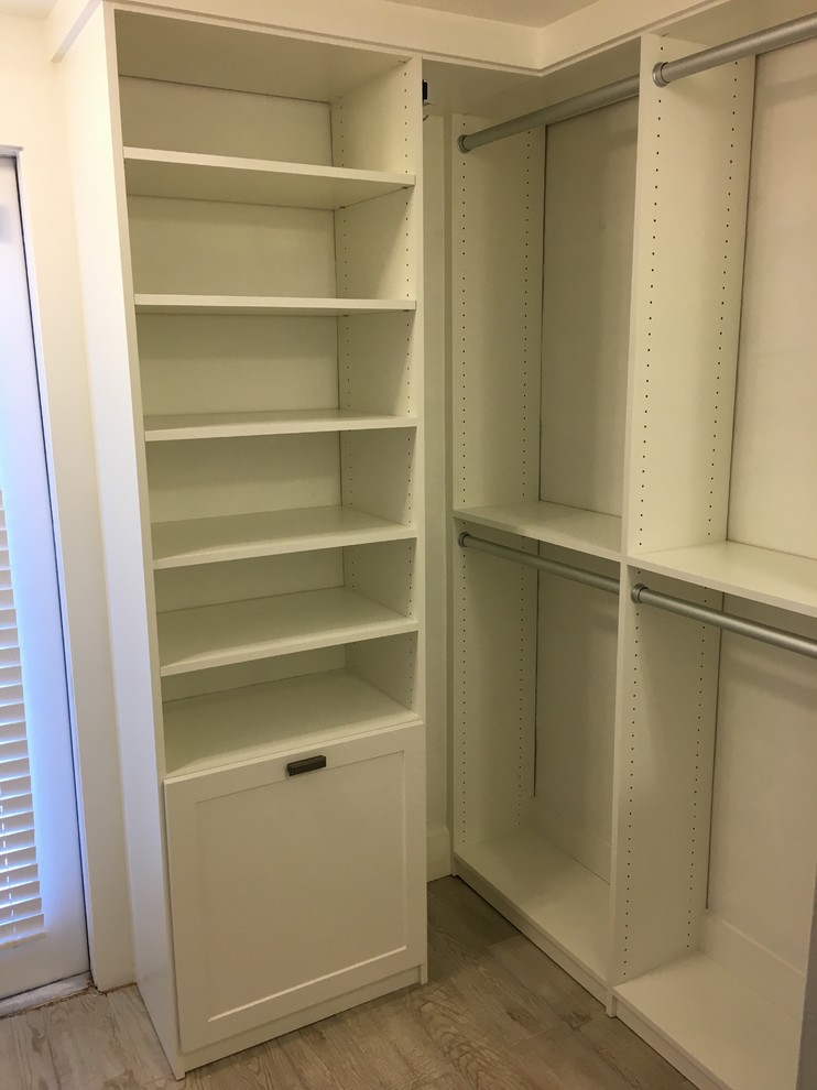 This is an example of a small contemporary walk-in wardrobe in Miami with shaker cabinets, white cabinets and porcelain floors.