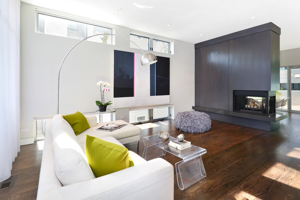 Photo of a modern living room in Chicago with a two-sided fireplace.