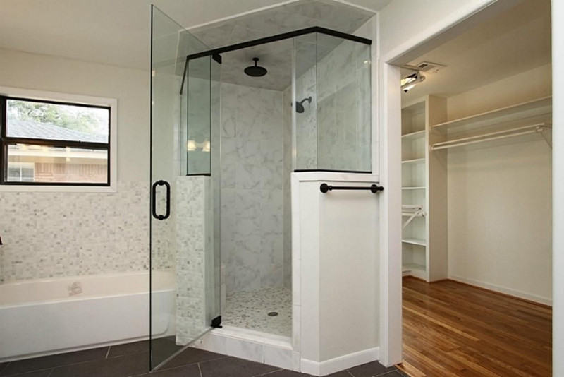 Design ideas for a large traditional master bathroom in New York with an alcove tub, a corner shower, gray tile, white tile, porcelain tile, grey walls, porcelain floors, an undermount sink, solid surface benchtops, brown floor and a hinged shower door.