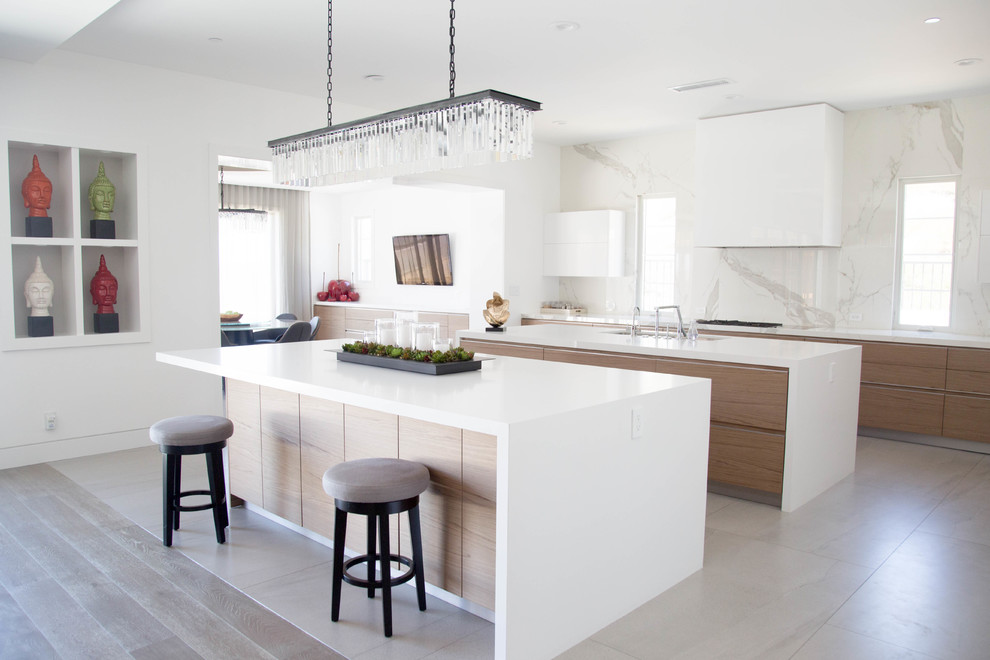 Design ideas for a contemporary kitchen in Orange County with an undermount sink, flat-panel cabinets, medium wood cabinets, porcelain splashback, multiple islands, grey floor and white benchtop.