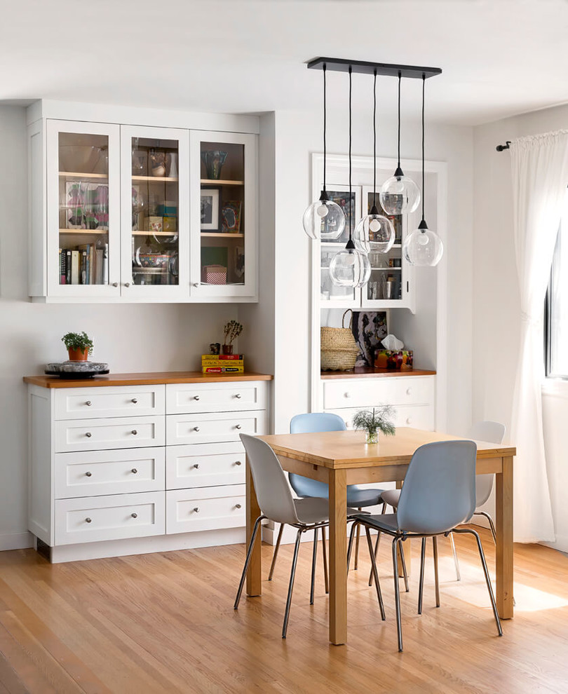 Inspiration for a midcentury kitchen/dining combo in Other with white walls and light hardwood floors.