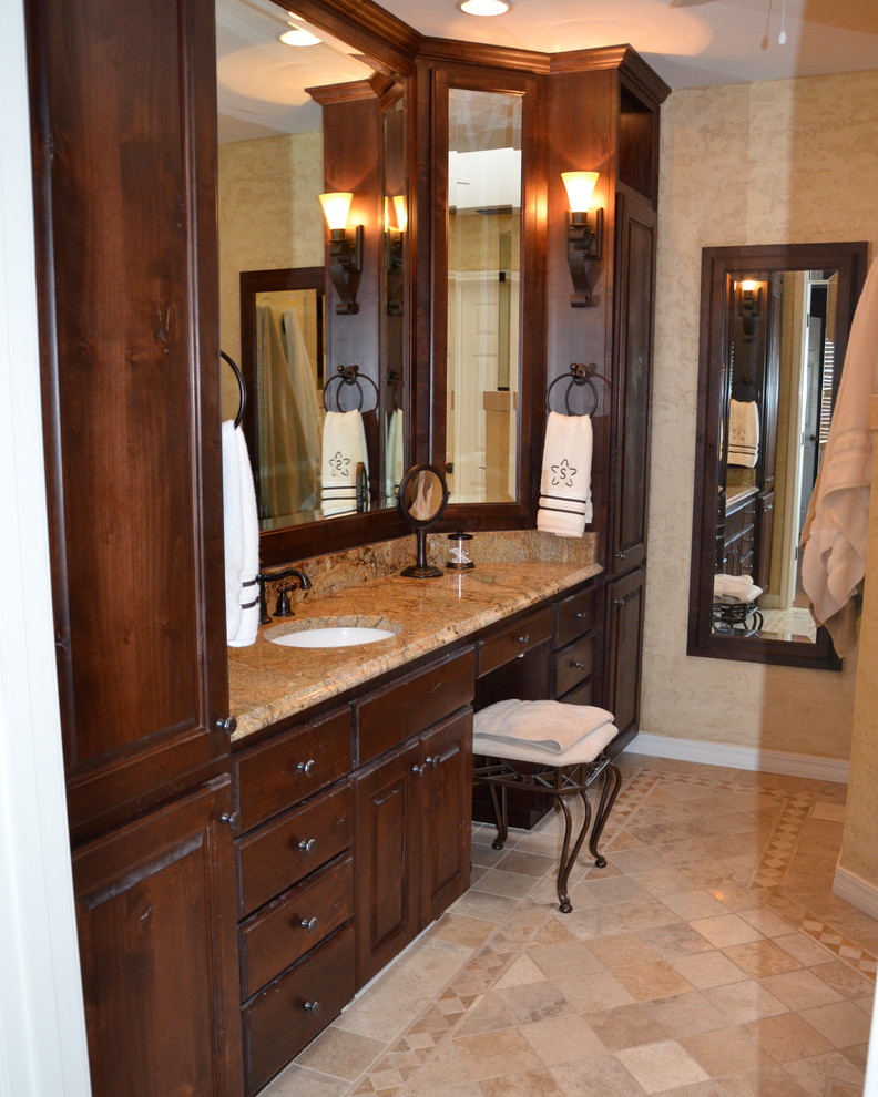 This is an example of a mid-sized traditional master bathroom in Austin with shaker cabinets, white cabinets, an alcove tub, an alcove shower, a one-piece toilet, green tile, glass tile, purple walls, dark hardwood floors, a vessel sink, marble benchtops, brown floor and a hinged shower door.