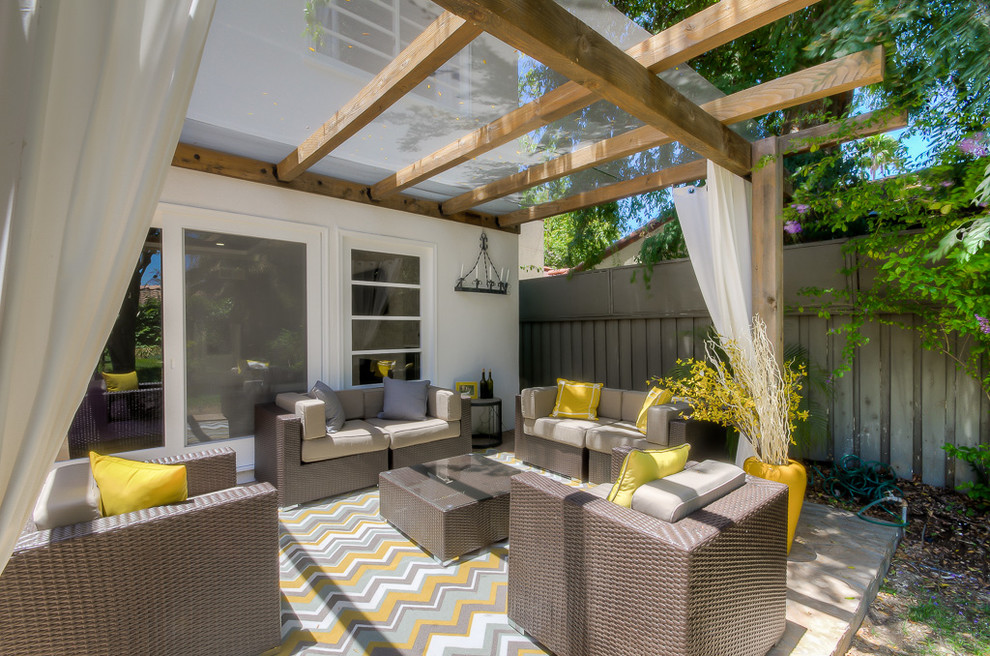 Inspiration for a mid-sized transitional backyard patio in Los Angeles with concrete slab and a pergola.