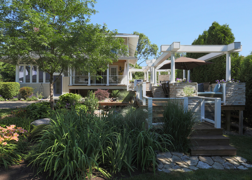 Outdoor kitchen deck - huge transitional backyard outdoor kitchen deck idea in Chicago with a pergola