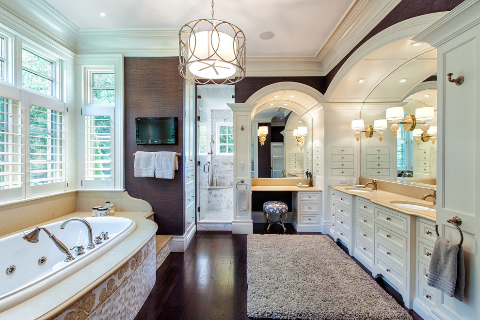 Example of a large mountain style master dark wood floor and brown floor bathroom design in Other with shaker cabinets, white cabinets, a two-piece toilet, brown walls, an undermount sink, solid surface countertops and a hinged shower door