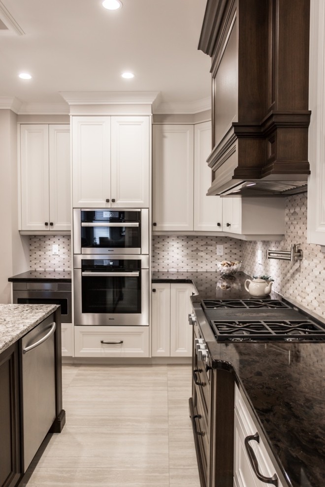 Mid-sized transitional l-shaped ceramic tile eat-in kitchen photo in Toronto with an undermount sink, shaker cabinets, granite countertops, mosaic tile backsplash, stainless steel appliances, an island, gray backsplash and white cabinets