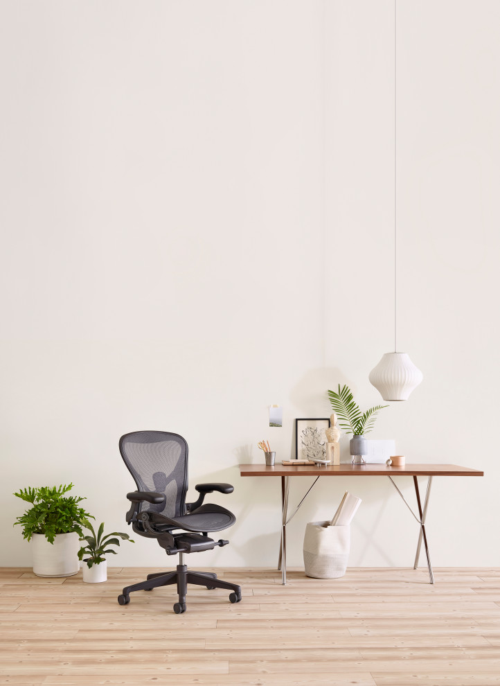 Trendy freestanding desk light wood floor and brown floor study room photo in Chicago with white walls and no fireplace