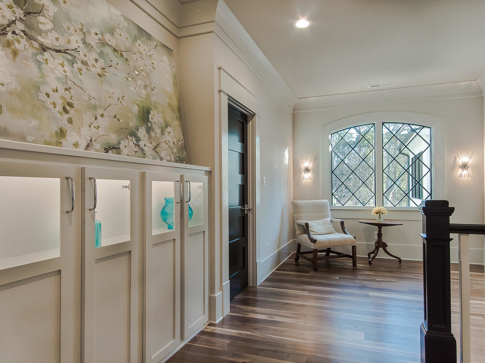 Inspiration for a large traditional hallway in Raleigh with white walls, dark hardwood floors and brown floor.