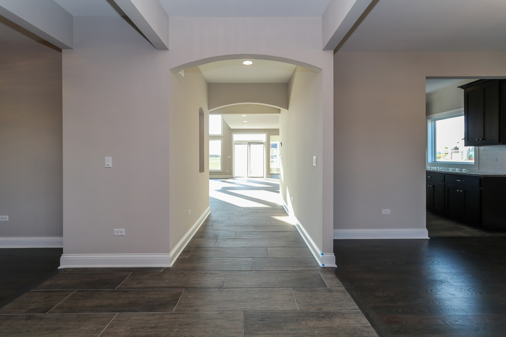 Photo of a mid-sized transitional foyer in Chicago with grey walls, ceramic floors and grey floor.