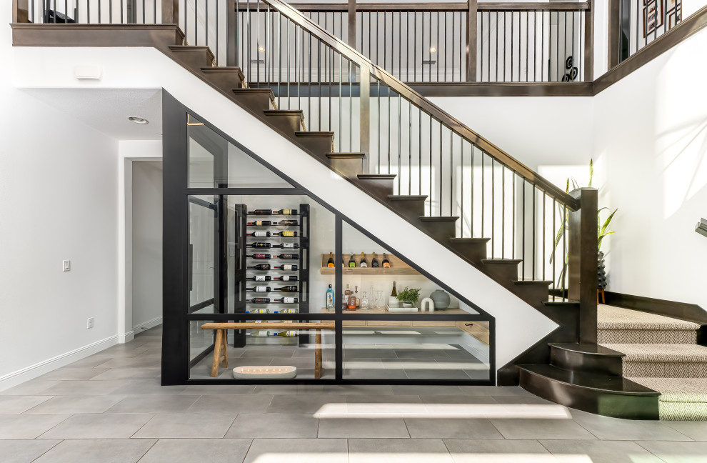 This is an example of a small contemporary wine cellar in Los Angeles with porcelain floors, display racks and grey floor.