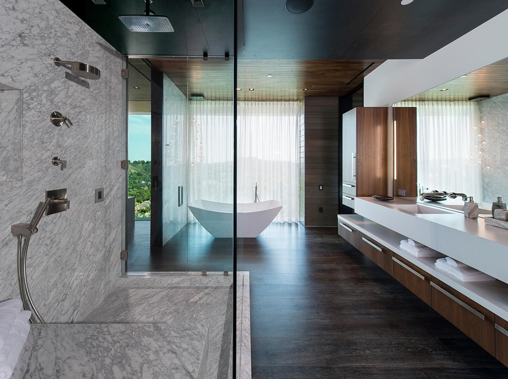 Inspiration for a large modern master bathroom in Los Angeles with furniture-like cabinets, brown cabinets, a freestanding tub, a corner shower, multi-coloured walls, medium hardwood floors, a wall-mount sink, brown floor, a hinged shower door, white benchtops, a double vanity, a floating vanity and recessed.
