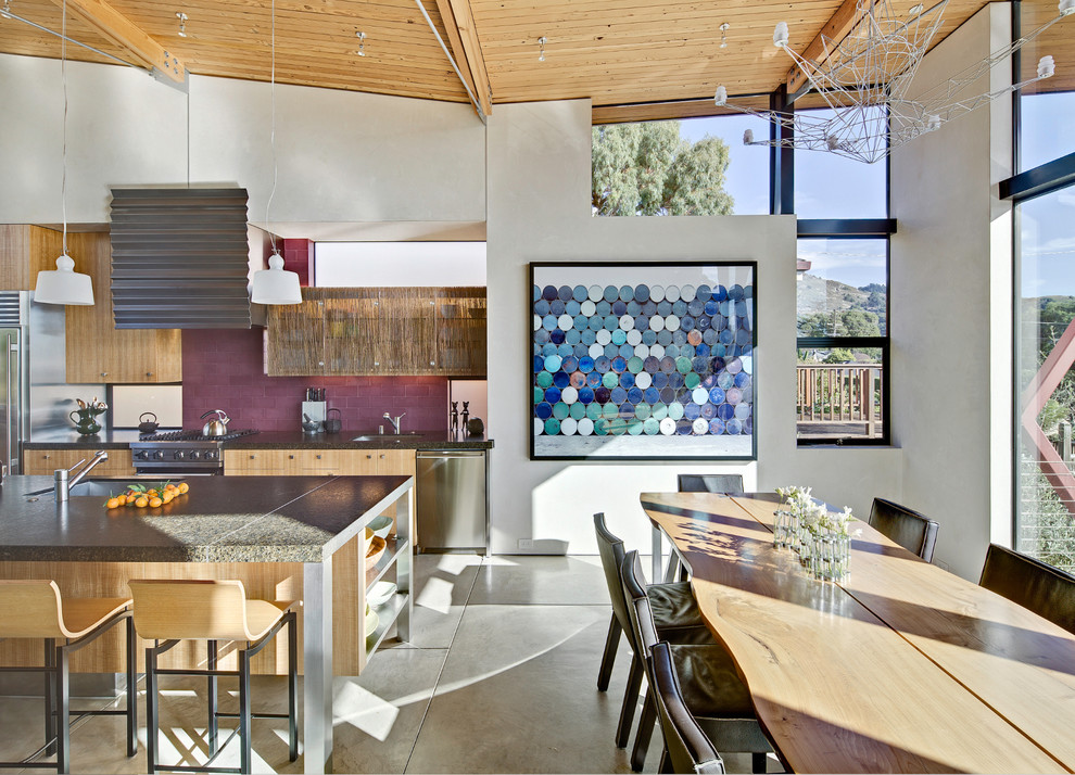 Mid-sized beach style open plan dining in San Francisco with concrete floors, white walls and no fireplace.