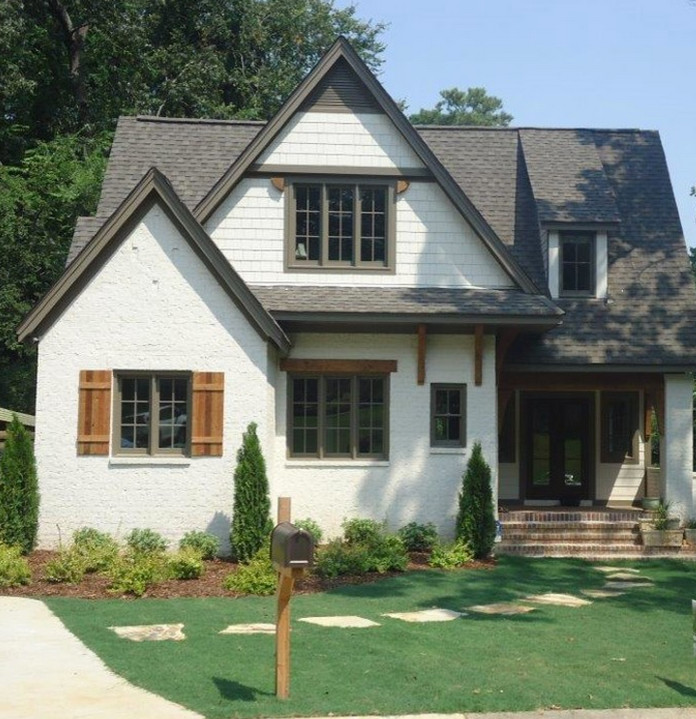 This is an example of a mid-sized arts and crafts two-storey brick white exterior in Birmingham.