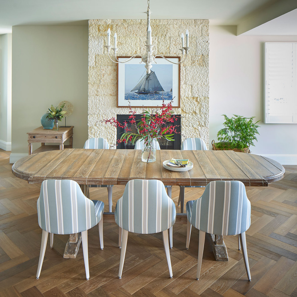 Design ideas for a large beach style open plan dining in Central Coast with white walls, medium hardwood floors, brown floor and brick walls.