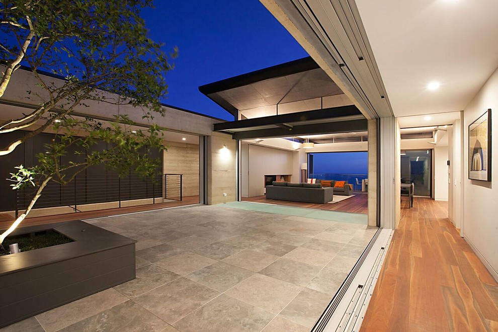 Design ideas for a mid-sized contemporary courtyard patio in Sydney with concrete pavers and no cover.