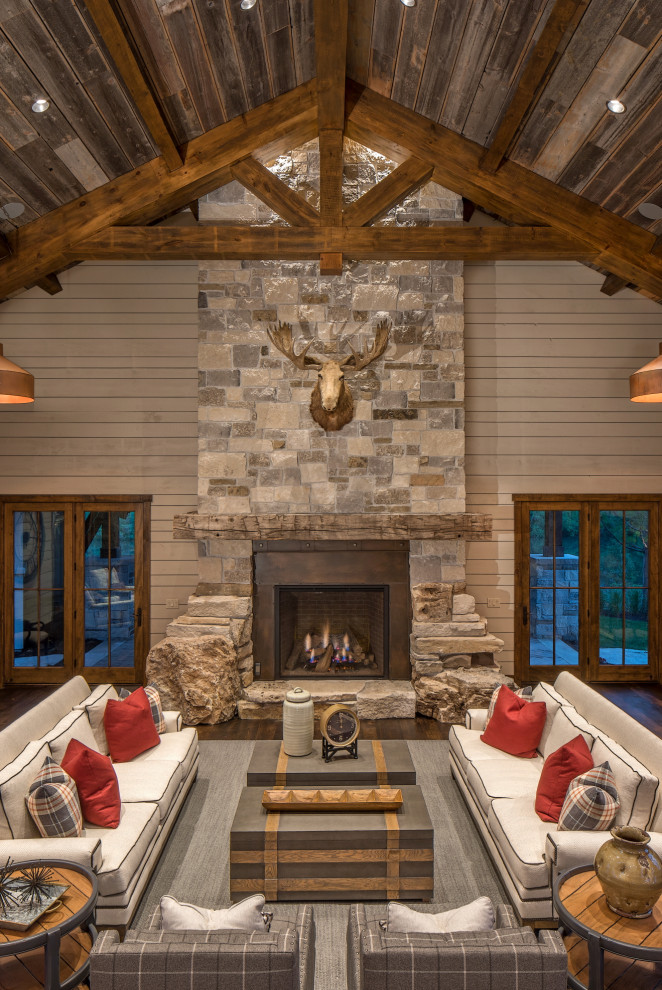 Inspiration for a country living room in Omaha with grey walls, dark hardwood floors, a standard fireplace and brown floor.