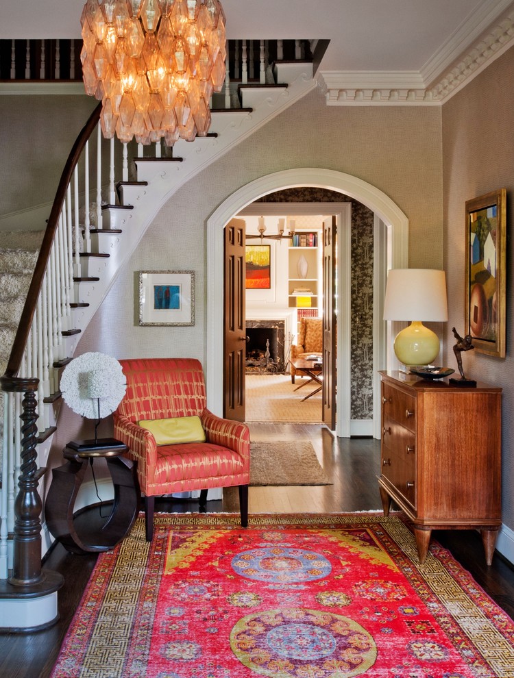 This is an example of a traditional foyer in Charlotte with grey walls and dark hardwood floors.