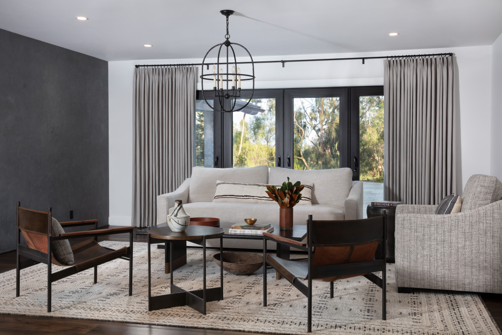 Photo of a medium sized classic enclosed living room in Santa Barbara with white walls, dark hardwood flooring and brown floors.