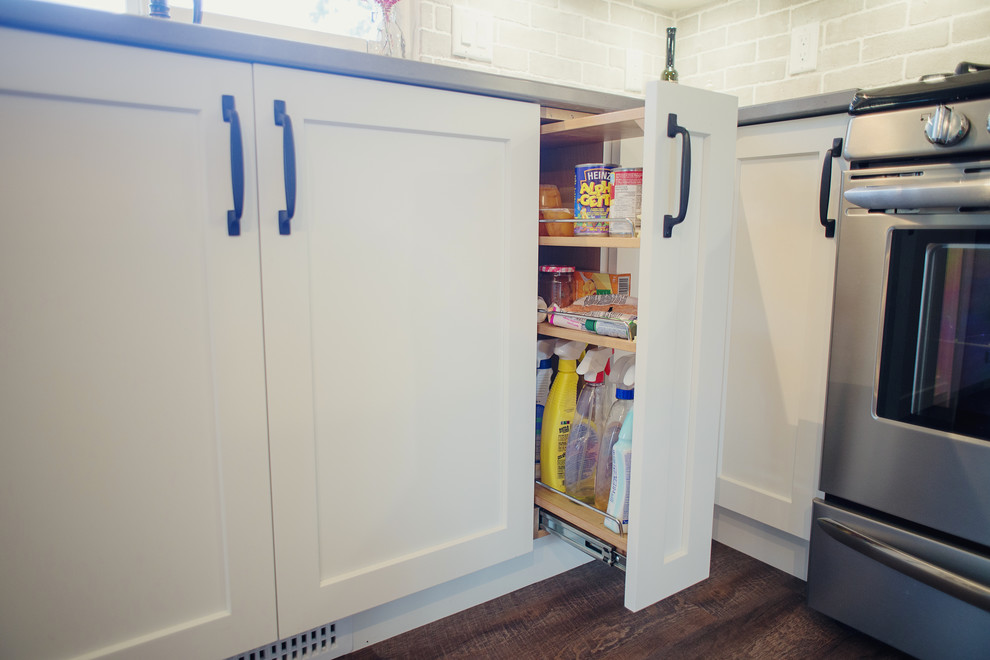 Inspiration for a mid-sized transitional l-shaped eat-in kitchen remodel in Vancouver with shaker cabinets, white cabinets, quartz countertops, gray backsplash, stainless steel appliances, an island, porcelain backsplash and white countertops