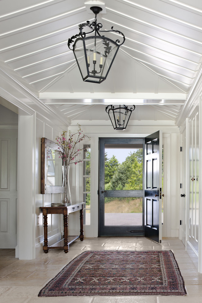 Photo of a country entryway in Boston with white walls, a single front door and a black front door.