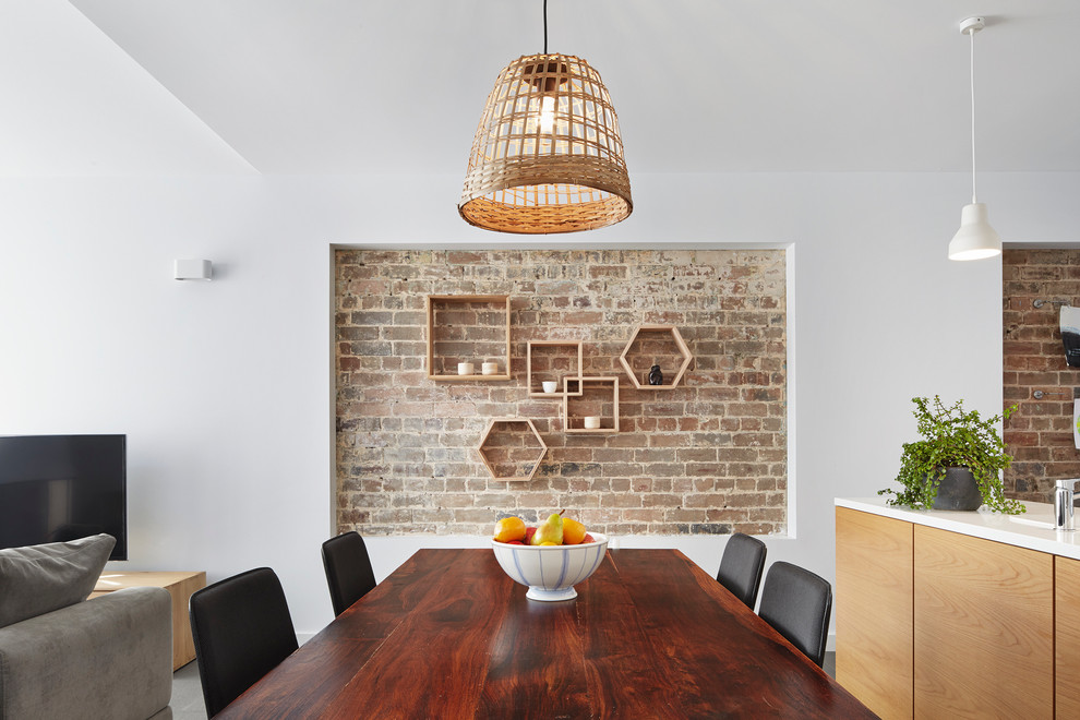 This is an example of a contemporary open plan dining in Sydney with white walls.