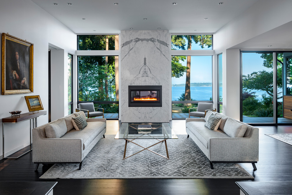 Photo of a contemporary formal open concept living room in Seattle with white walls, dark hardwood floors, a ribbon fireplace, a stone fireplace surround and brown floor.