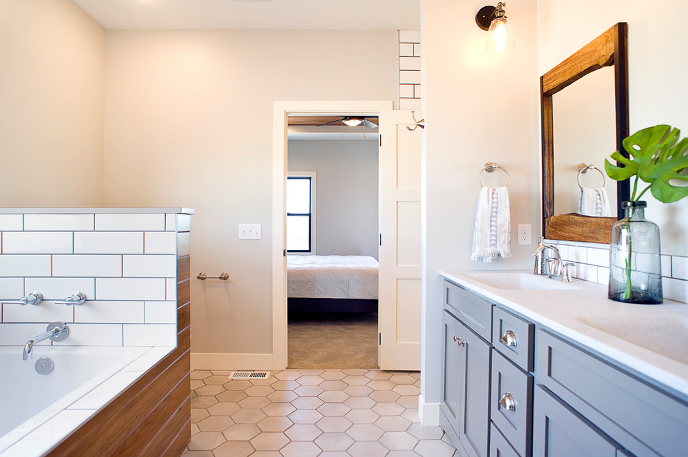 This is an example of a large transitional master bathroom in Other with shaker cabinets, green cabinets, a drop-in tub, an open shower, a one-piece toilet, white tile, subway tile, grey walls, ceramic floors, an integrated sink, onyx benchtops, beige floor, an open shower and yellow benchtops.