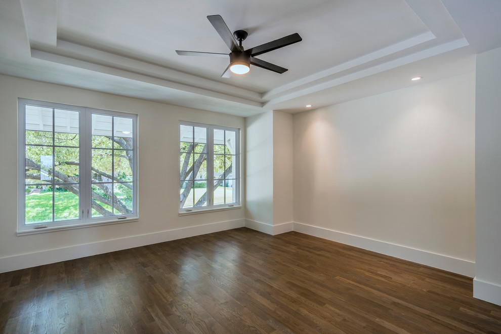 Example of a transitional master medium tone wood floor home design design in Dallas with white walls