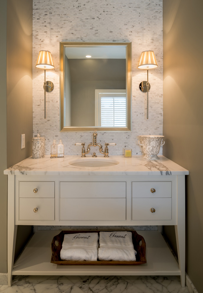 Design ideas for a traditional powder room in Philadelphia with furniture-like cabinets, marble benchtops, white tile, marble and white benchtops.